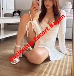 Woman in a white wrap dress sits on the floor taking a mirror selfie; red ad text 'Gaziantep Escort Bayan' spans the image.