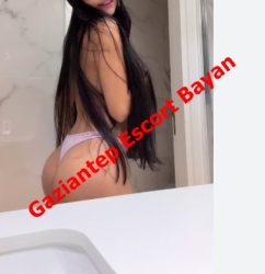 Woman with long black hair in a pink thong posing in a bathroom; diagonal red watermark says Gaziantep Escort Bayan.